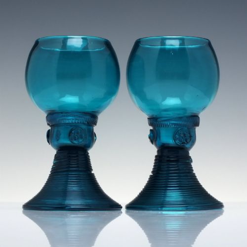 fig 1. A pair of early 19th-century peacock blue glass roemers with globular bowls, prunted stems, and broad coiled pedestals.