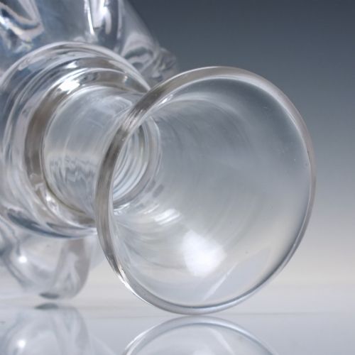 fig 2. A clear glass wine carafe featuring a bulbous body with vertical pillar moulding, applied neck rings, and a flared rim.