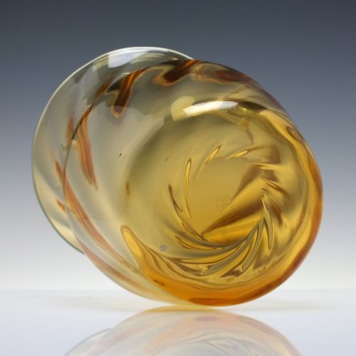 fig 3. An amber crystal vase featuring a twisted optical swirl pattern and a flared rim.