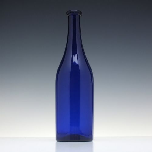 fig 2. A dark cobalt blue Victorian hand-blown glass serving bottle featuring a tapered neck, double collar, and smooth cylindrical body.