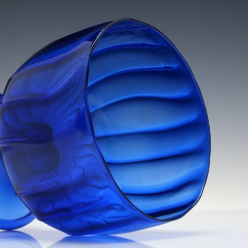 fig 3. A deep cobalt blue glass sugar bowl featuring a vertically ribbed body set upon a conical pedestal foot.