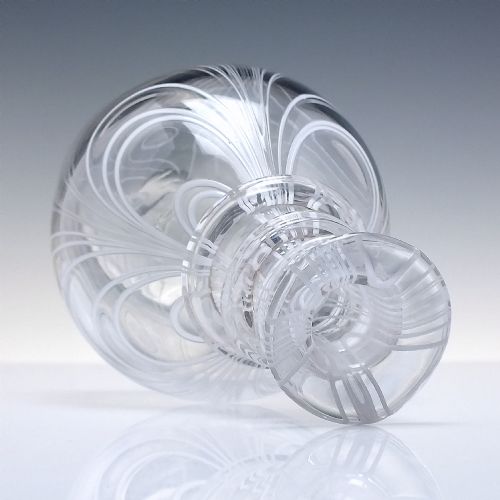 fig 5. A clear lead glass Regency Prussian-shaped personal spirit decanter decorated with combed opaque white trailing and fitted with a matching glass stopper.