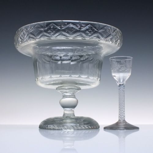 fig 1. A clear Georgian cut glass standing bowl featuring a wide diamond-cut rim, fluted basin, knopped stem, and circular foot.
