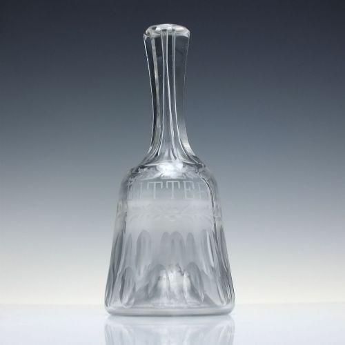 fig 2. A pair of 18th-century clear glass sugar loaf bitters bottles featuring facet-cut long necks, hand-engraved floral garlands, and the word BITTERS cut into the body.