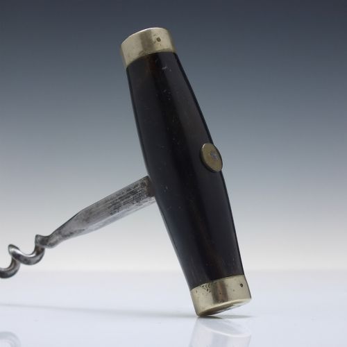 fig 1. A Victorian direct-pull corkscrew featuring a T-bar handle made of dark polished horn capped with silver-plated ends and a steel helix worm.