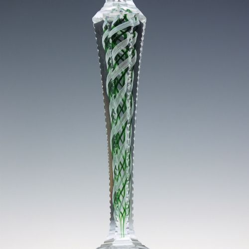 fig 4. A pair of clear glass wine goblets featuring round bowls and tall stems decorated with internal green and white opaque twists.
