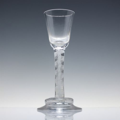fig 1. A clear Georgian lead glass wine glass featuring an internal white opaque twist stem and a stepped helmet foot.