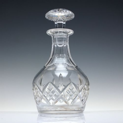 fig 1. A clear cut lead crystal spirit decanter featuring a geometric diamond-cut lower body and a matching faceted glass stopper.