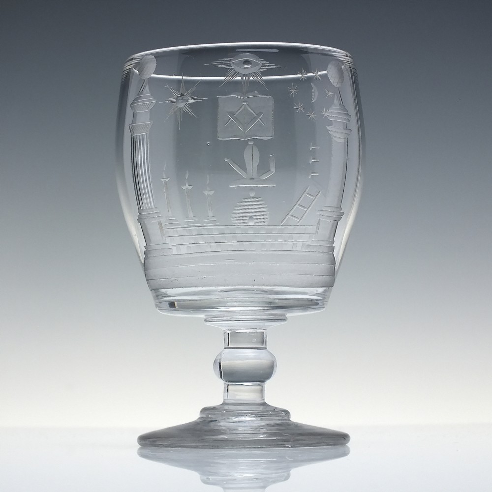 A clear 19th-century glass rummer featuring detailed wheel-engraved Masonic symbols, a knopped stem, and a flat circular base. View II