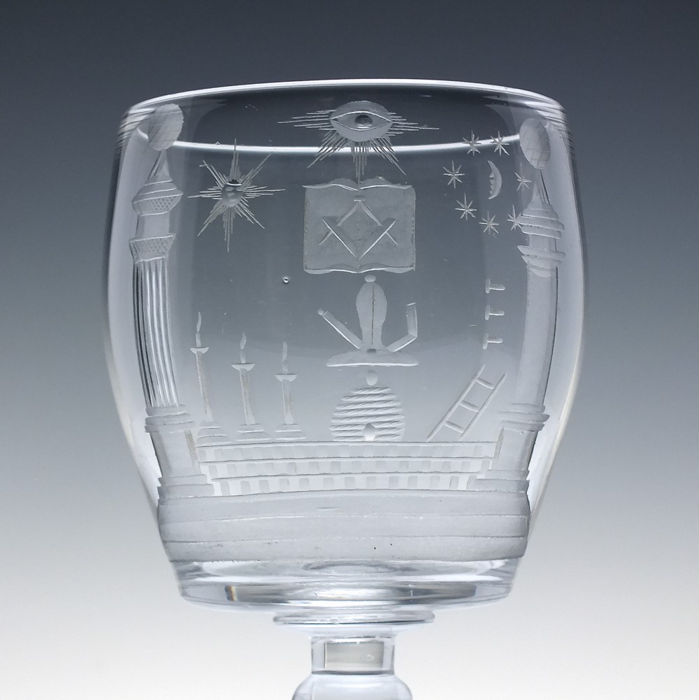 A clear 19th-century glass rummer featuring detailed wheel-engraved Masonic symbols, a knopped stem, and a flat circular base. View III
