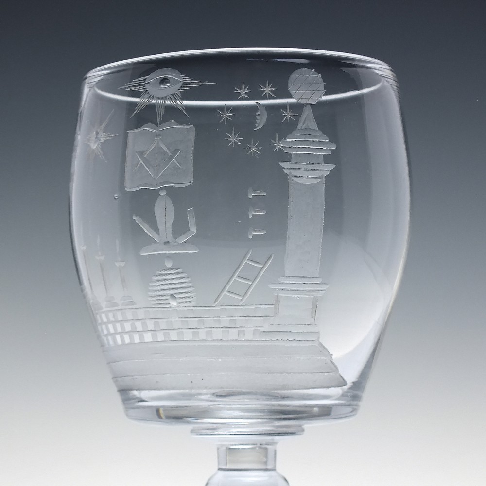 A clear 19th-century glass rummer featuring detailed wheel-engraved Masonic symbols, a knopped stem, and a flat circular base. View IV