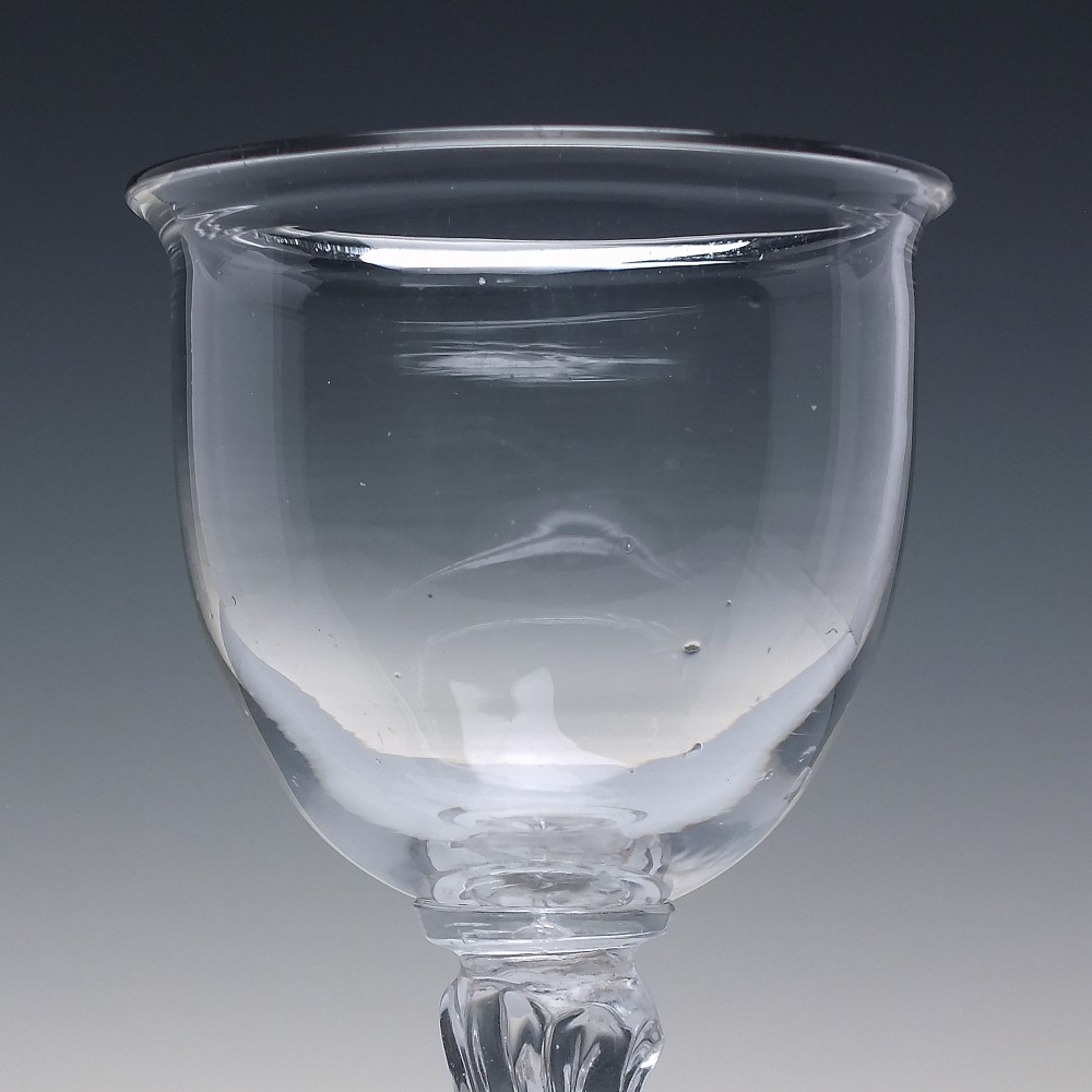 An 18th-century clear glass goblet featuring a bucket bowl supported by a ribbed pedestal stem and a flared round foot. View IV