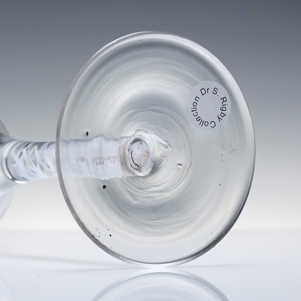 A Georgian wine glass featuring a clear trumpet-shaped bowl resting on a straight stem with an internal white opaque double series twist spiral and a conical foot. View VI