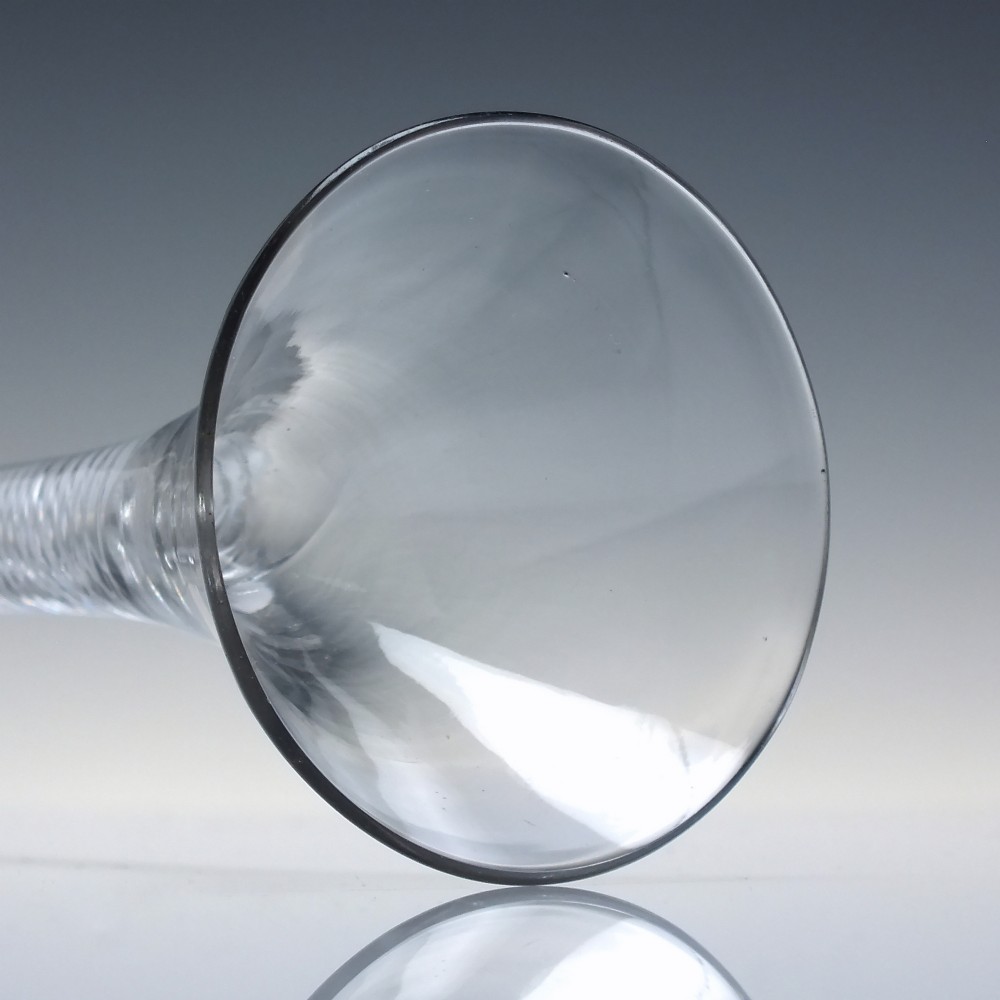 An 18th-century Georgian clear lead glass wine glass featuring a flared bell bowl, an air twist stem with a central knop, and a wide domed foot. View V
