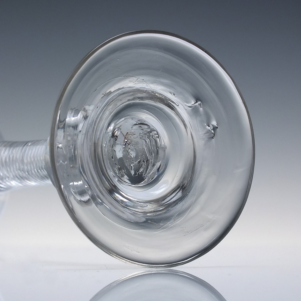 An 18th-century Georgian clear lead glass wine glass featuring a flared bell bowl, an air twist stem with a central knop, and a wide domed foot. View VI