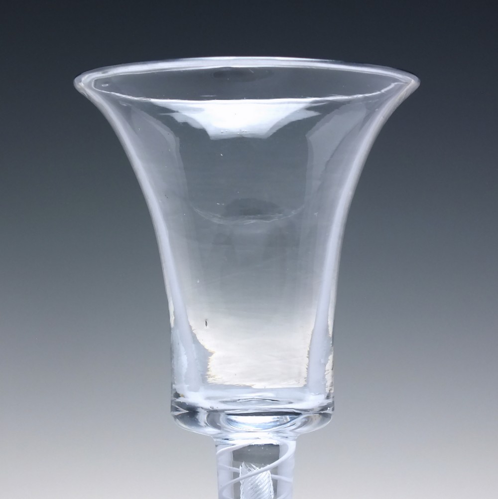 An eighteenth-century clear lead glass wine glass featuring a flared bucket bowl and a mixed twist stem on a conical foot. View IV