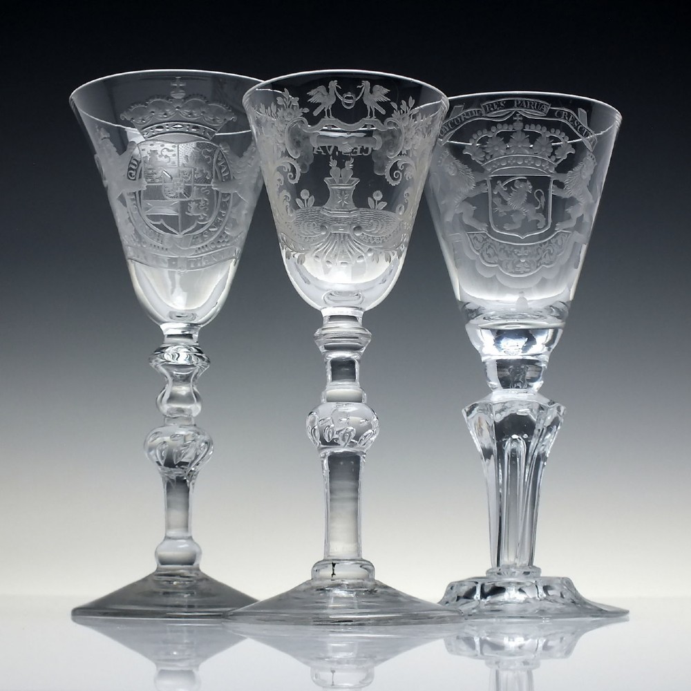 An 18th-century clear lead glass wine goblet featuring detailed wheel-engraved marriage motifs on the bowl and a knopped light baluster stem. View II