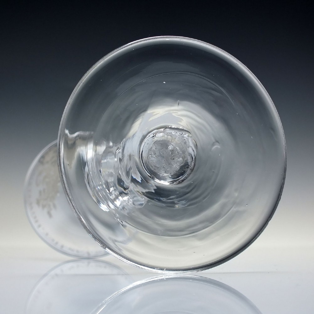 An 18th-century clear lead glass wine goblet featuring detailed wheel-engraved marriage motifs on the bowl and a knopped light baluster stem. View XI