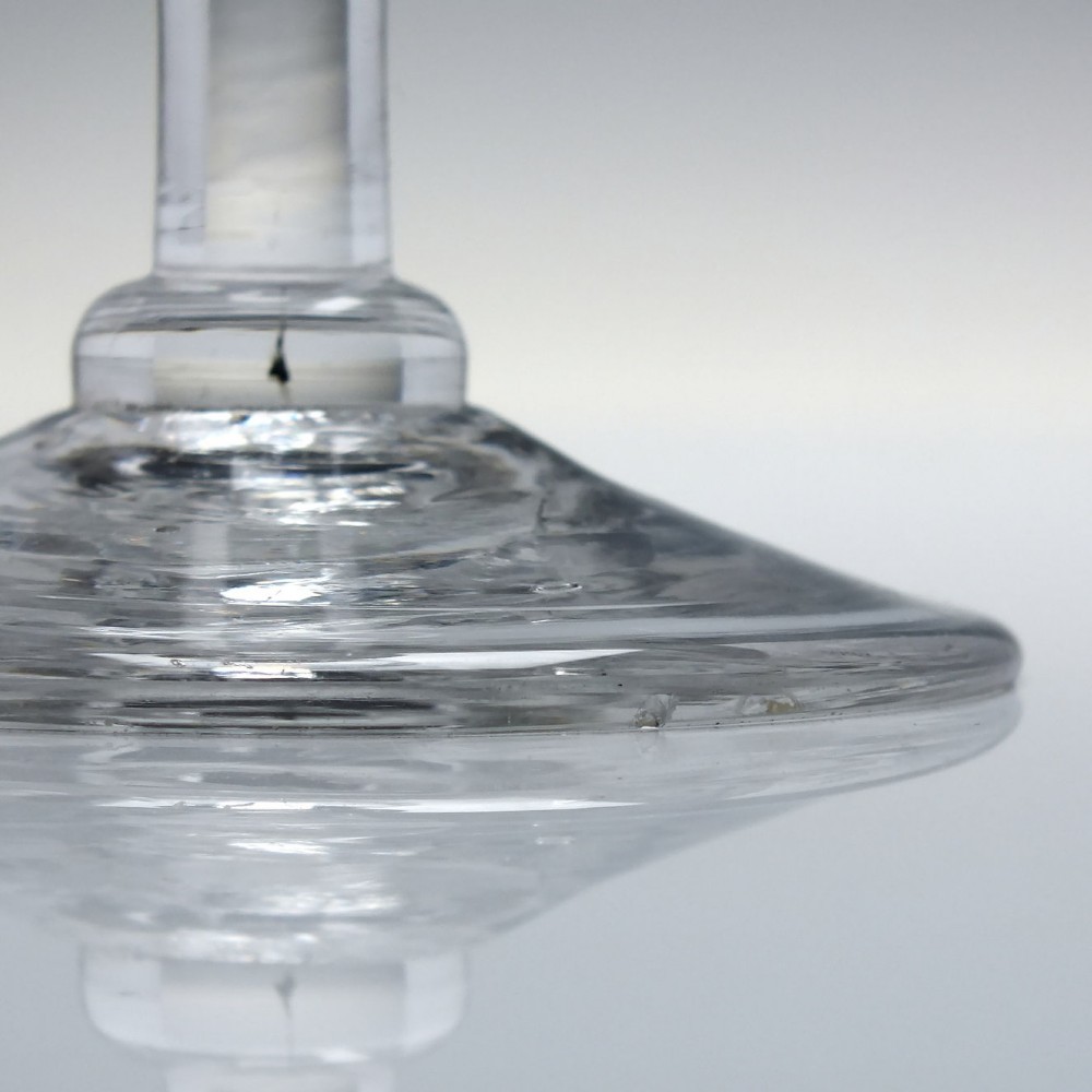 An 18th-century clear lead glass wine goblet featuring detailed wheel-engraved marriage motifs on the bowl and a knopped light baluster stem. View XII
