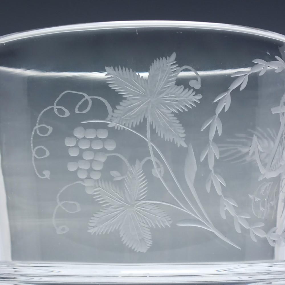 A clear Georgian lead crystal flip glass tumbler featuring lower cut panel flutes, a central waist ring, and upper wheel-engraved anchor and laurel wreath motifs. View III