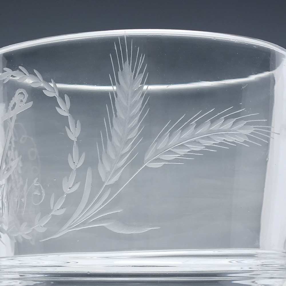 A clear Georgian lead crystal flip glass tumbler featuring lower cut panel flutes, a central waist ring, and upper wheel-engraved anchor and laurel wreath motifs. View IV