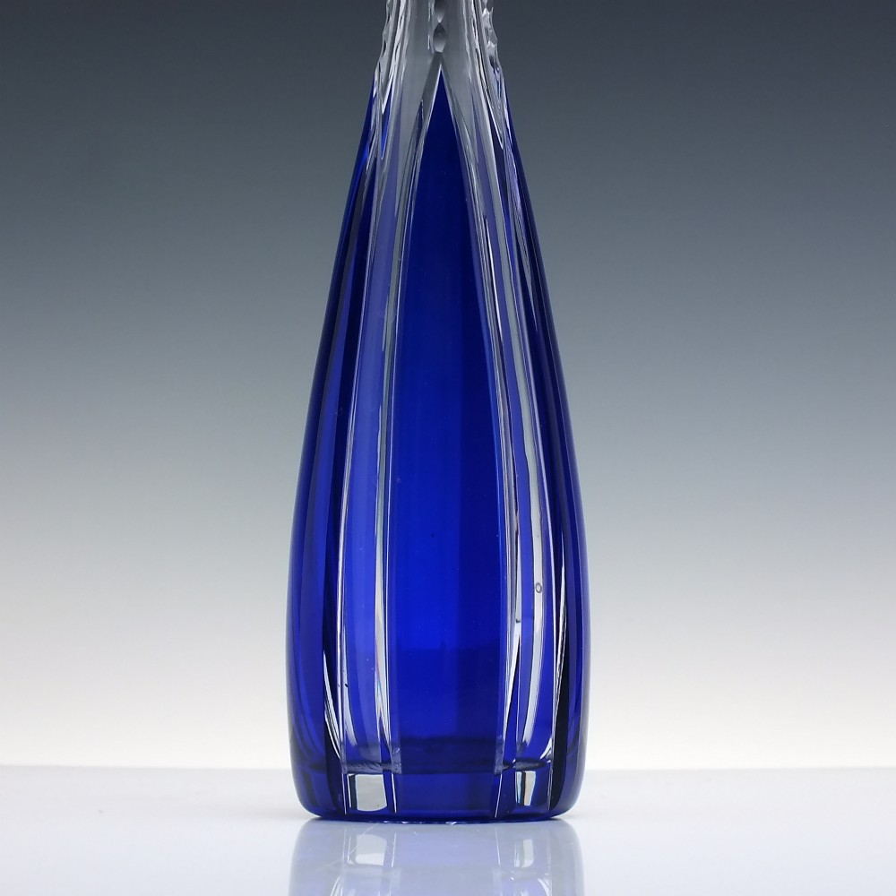 A tall, slender cobalt blue cut-to-clear crystal spirit decanter featuring vertical faceted flutes and a pointed, clear faceted stopper. View III