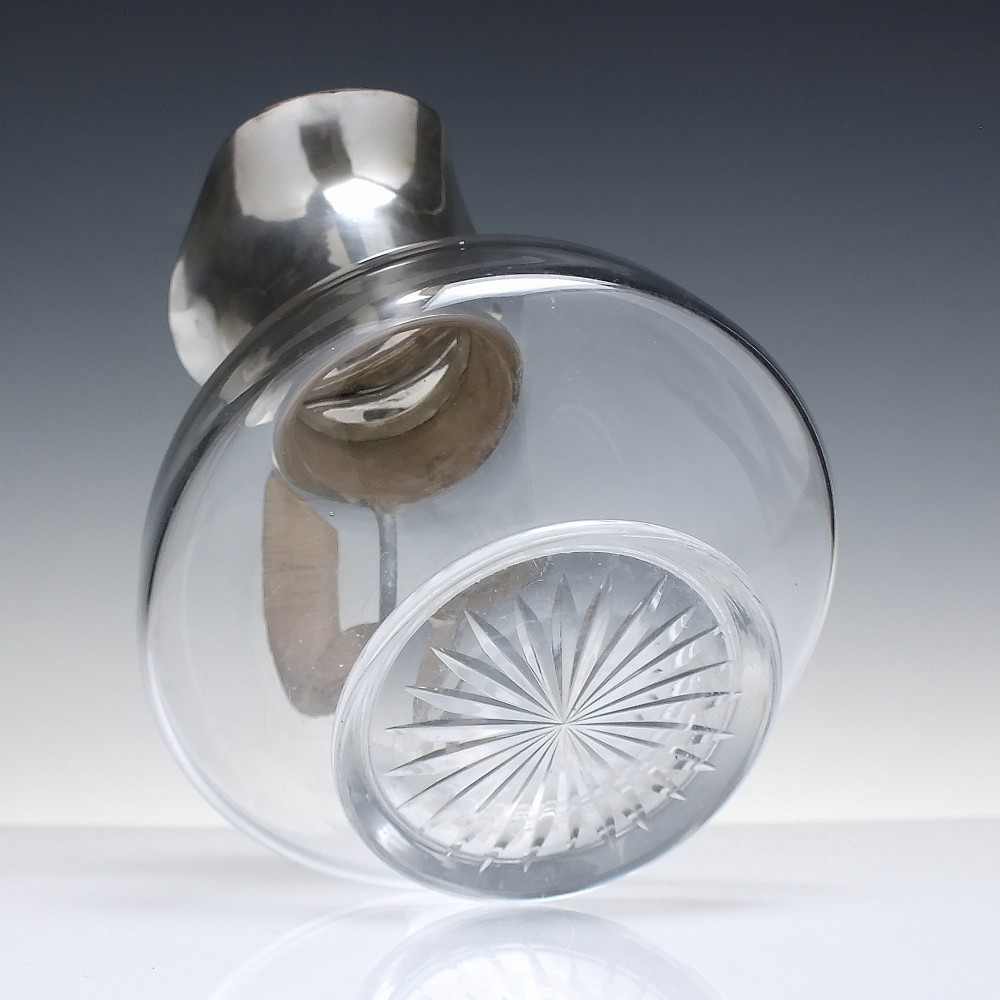 A late Victorian clear glass claret jug featuring a silver-plated neck, hinged lid, spout, and a cane-wrapped curved handle. View VII