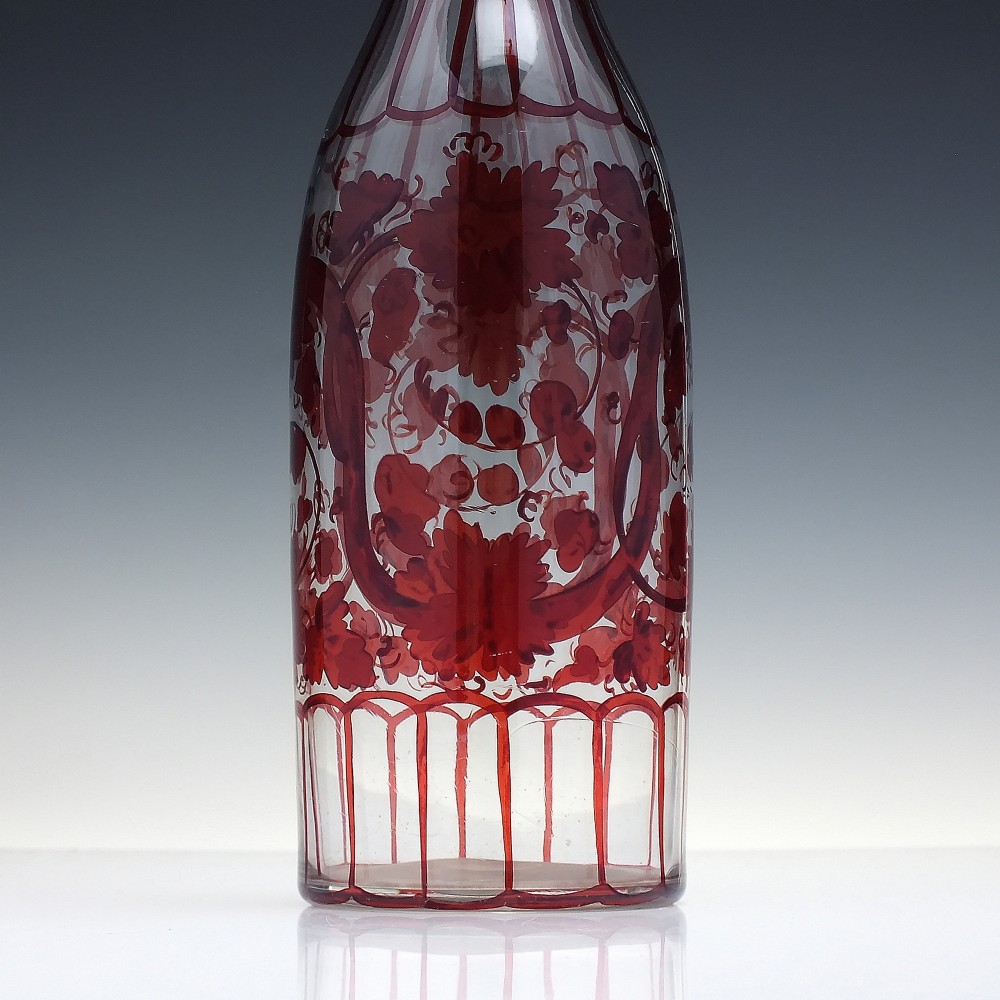 A tall clear glass decanter featuring red hand-painted floral motifs, vertical stripes, and a faceted glass stopper. View III