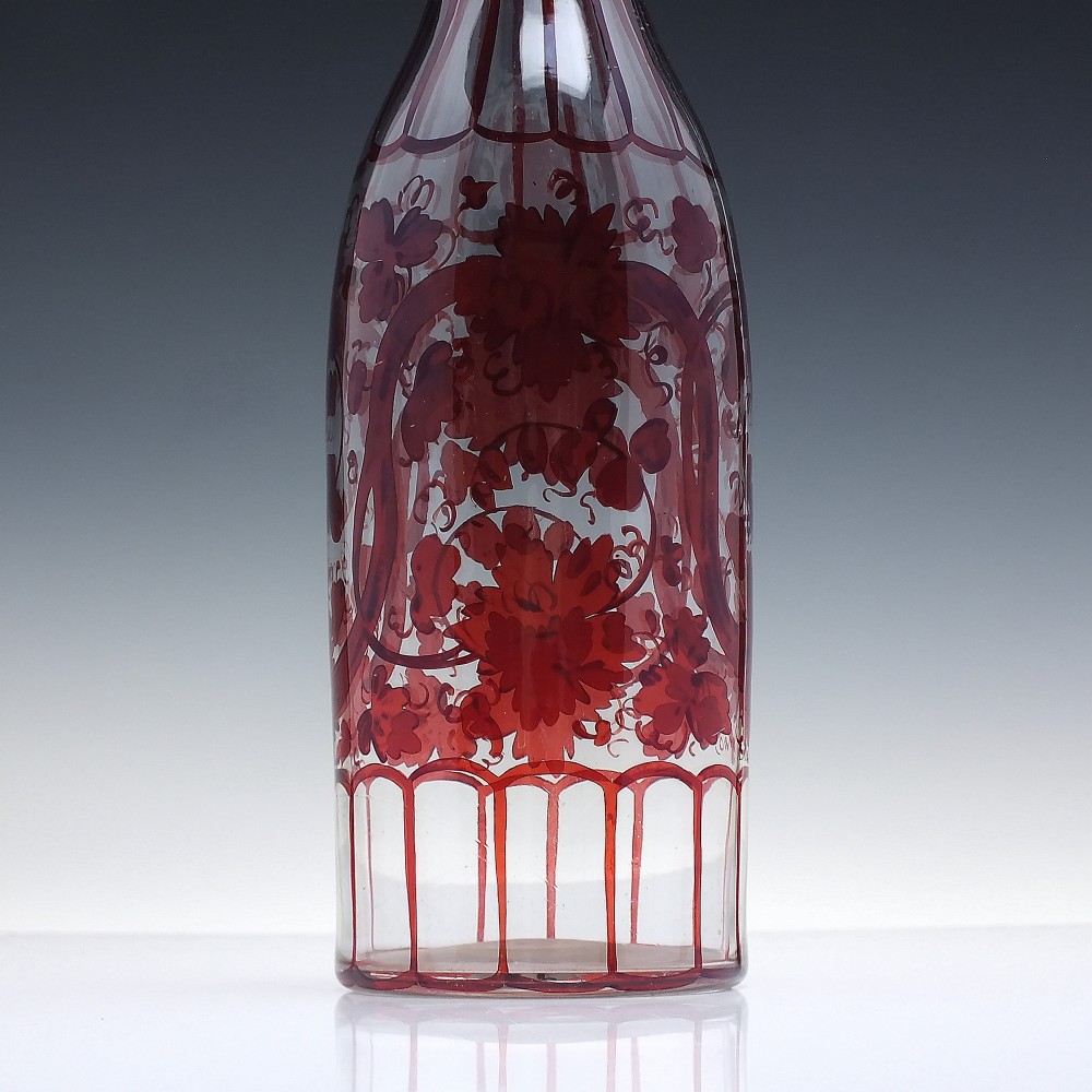 A tall clear glass decanter featuring red hand-painted floral motifs, vertical stripes, and a faceted glass stopper. View IV