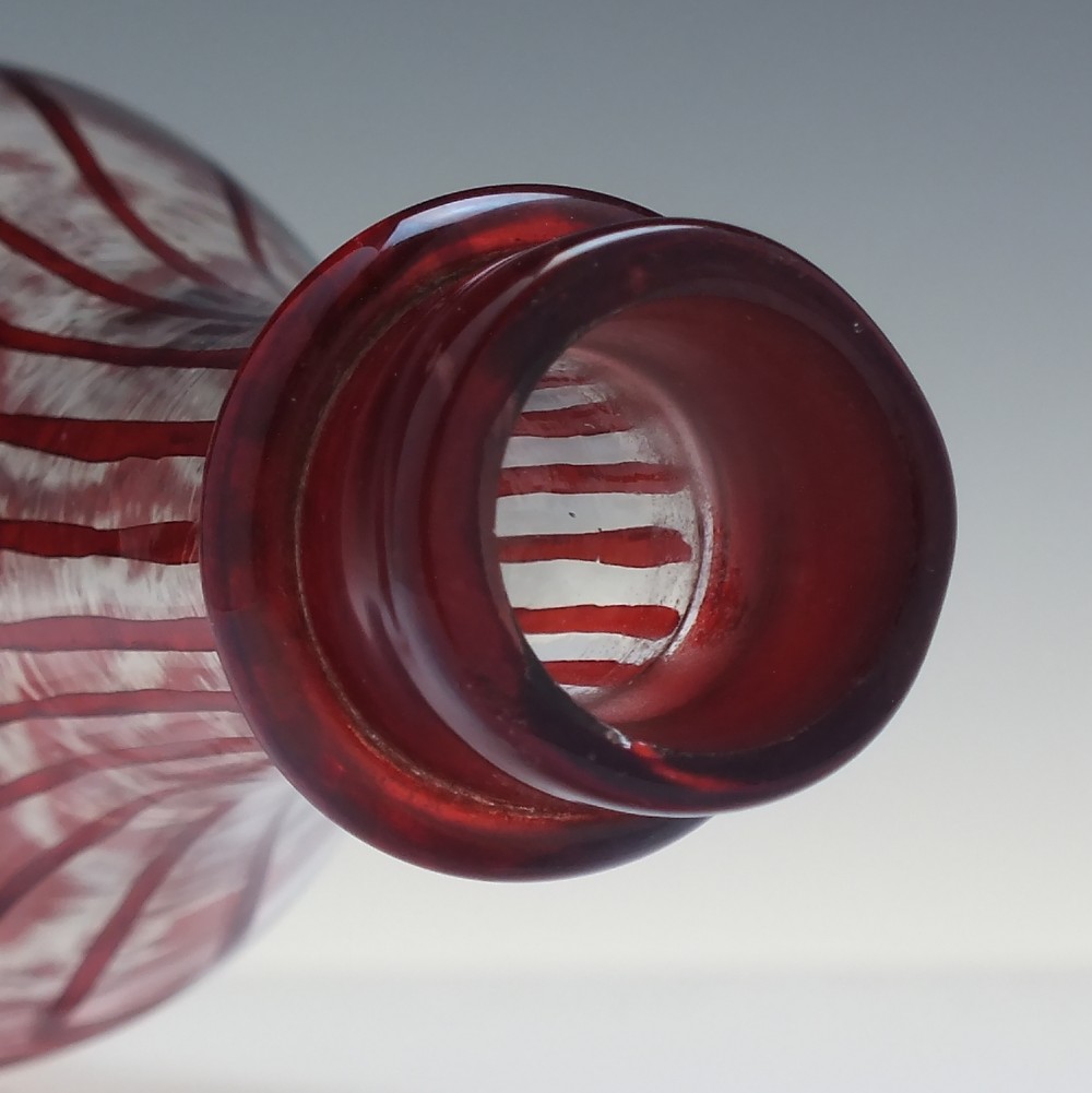 A tall clear glass decanter featuring red hand-painted floral motifs, vertical stripes, and a faceted glass stopper. View VI