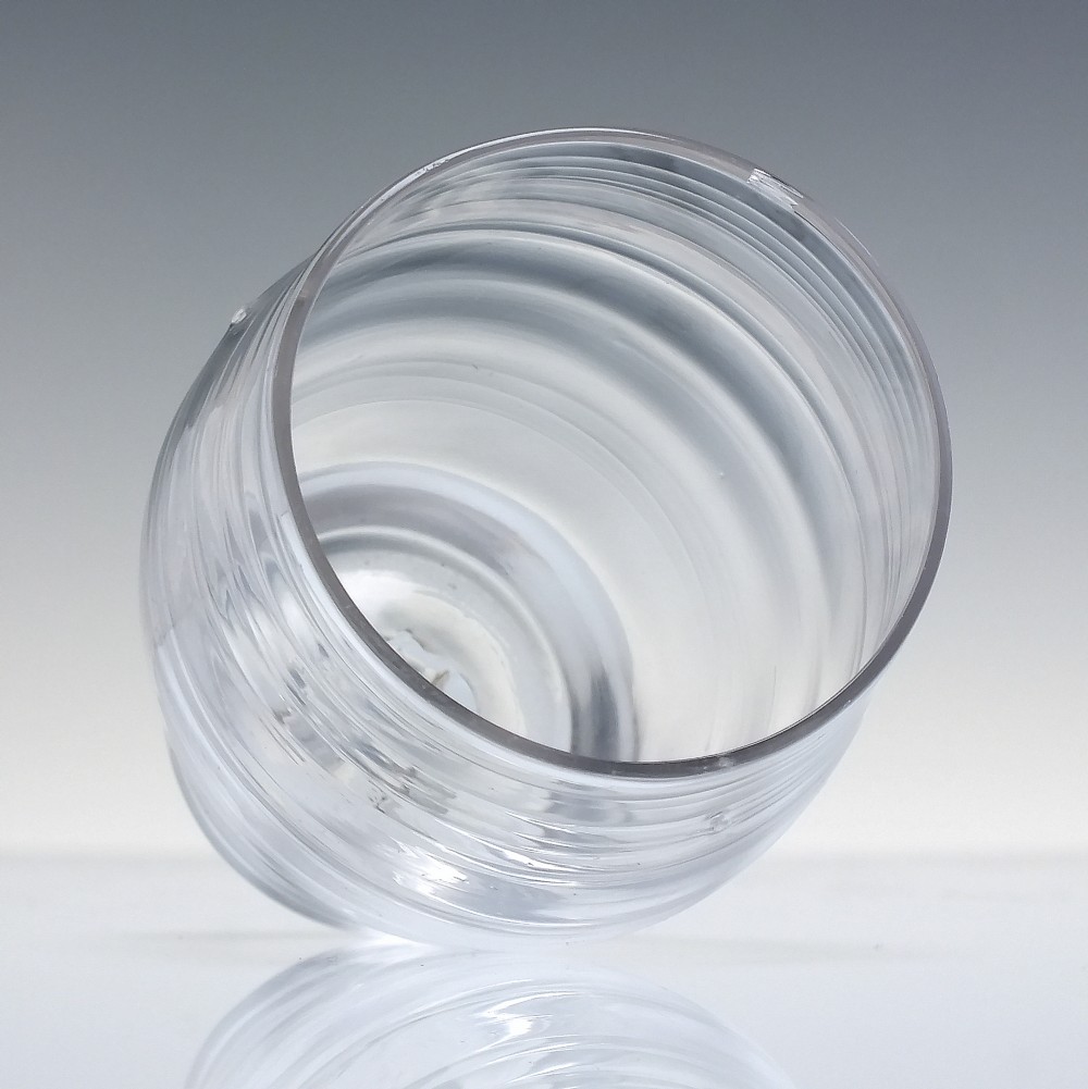 An 18th-century clear lead glass barrel-shaped dram tumbler featuring horizontal moulded rings around the exterior. View III