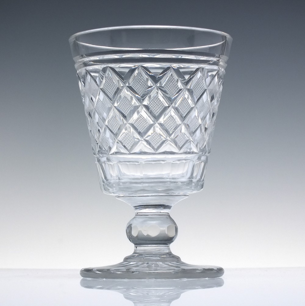 A clear Georgian cut lead crystal glass rummer featuring diamond-patterned facets and a knopped stem. View II