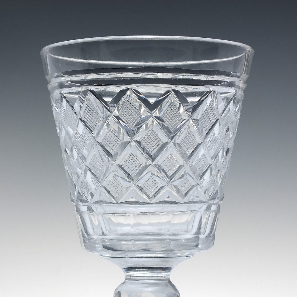A clear Georgian cut lead crystal glass rummer featuring diamond-patterned facets and a knopped stem. View III