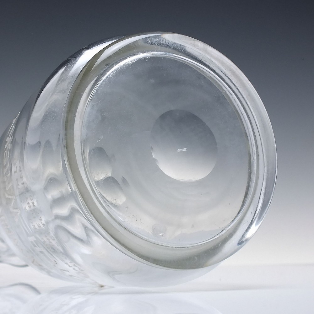 A clear glass antique whisky water carafe featuring white enamelled lettering for Dalwhinnie Scotch Whisky and a pinched pour spout. View VIII