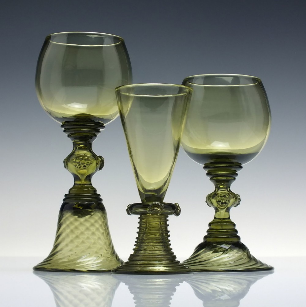 An olive green glass roemer goblet featuring a bulbous bowl, a central stem adorned with applied prunts, and a flared ribbed pedestal base. View II