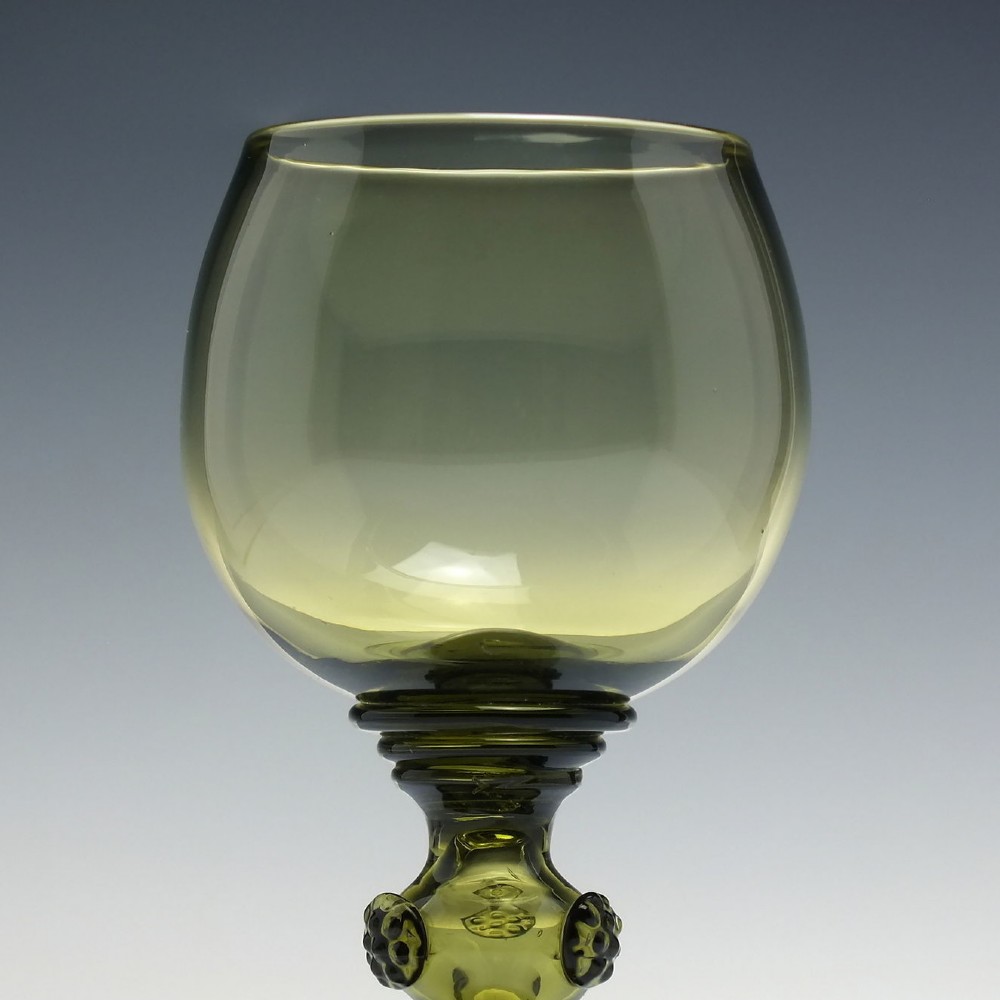 An olive green glass roemer goblet featuring a bulbous bowl, a central stem adorned with applied prunts, and a flared ribbed pedestal base. View III