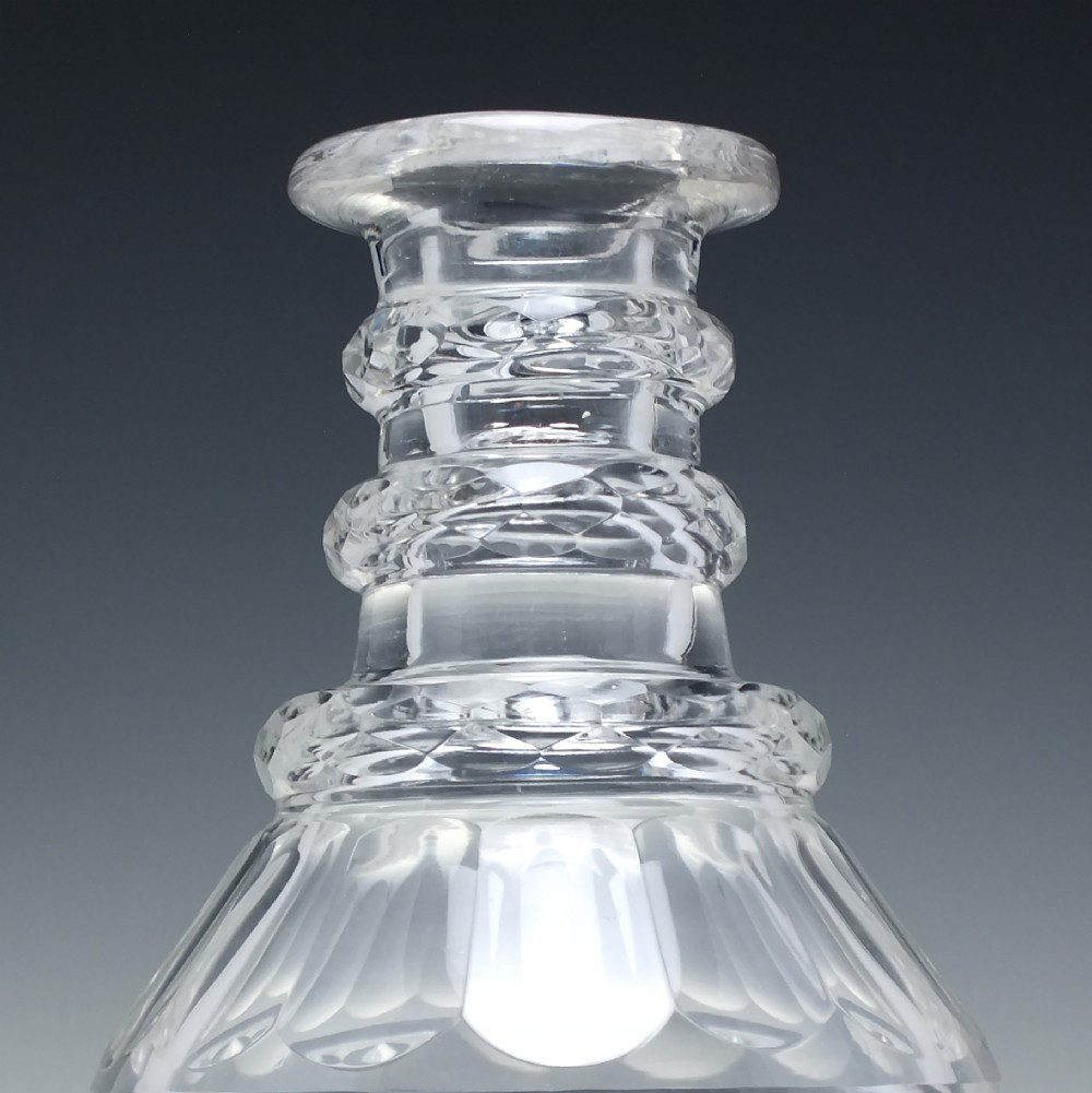 A clear Victorian cut glass wine decanter featuring a diamond-patterned lower body, ringed neck, and a matching faceted stopper. View IV