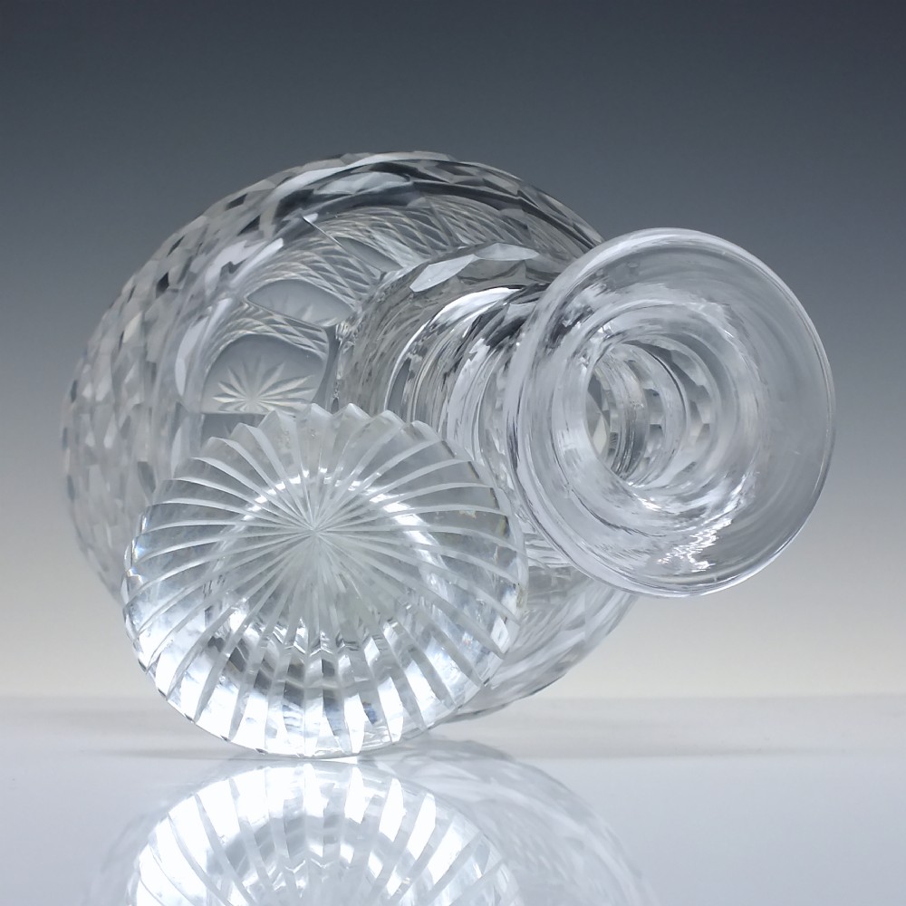 A clear Victorian cut glass wine decanter featuring a diamond-patterned lower body, ringed neck, and a matching faceted stopper. View VI