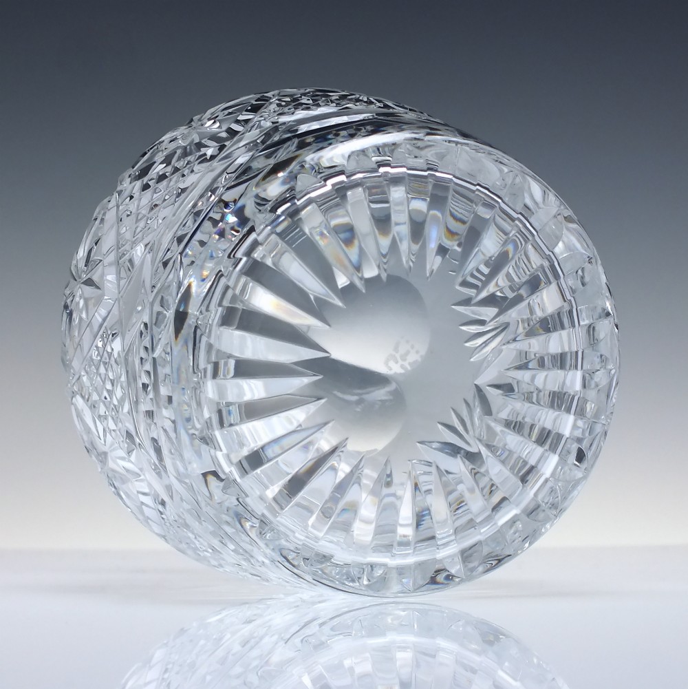 A clear cut lead crystal spirit decanter with starburst patterning and a fitted flat-topped glass stopper. View V