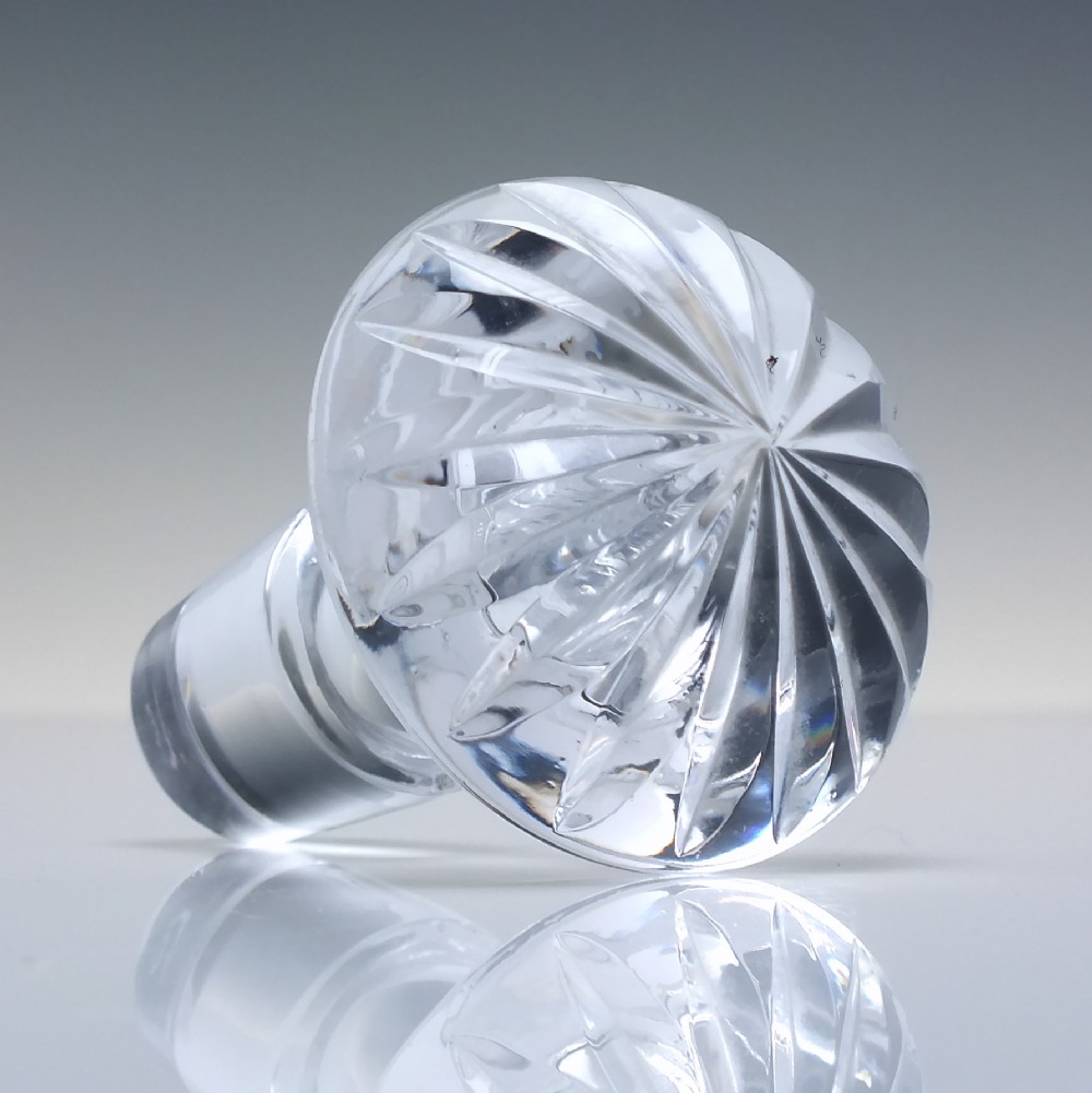 A clear cut lead crystal spirit decanter with starburst patterning and a fitted flat-topped glass stopper. View VIII