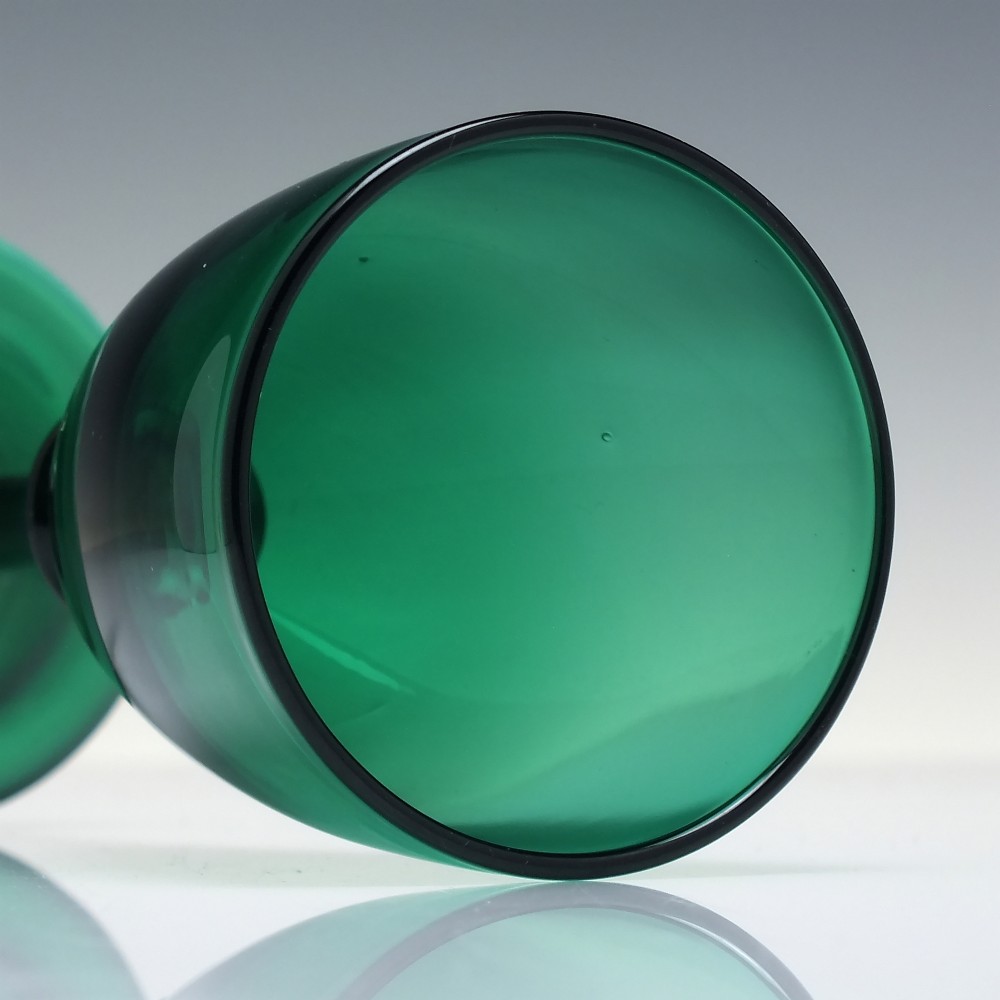 A mid-nineteenth-century wine glass made from deep emerald green glass with a slender stem and flat circular foot. View V