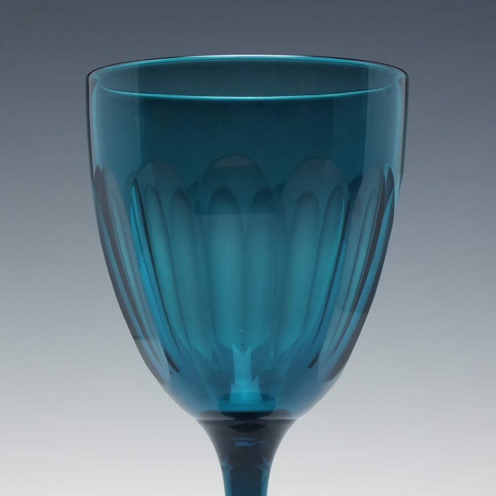 A Victorian peacock blue glass wine goblet featuring a panelled bowl, plain stem, and circular base. View III