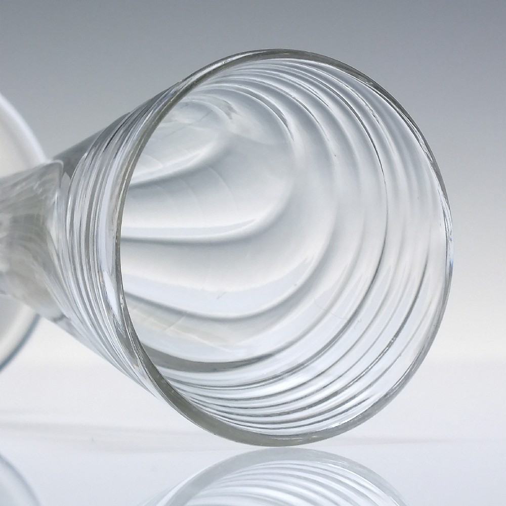 An eighteenth-century clear glass ale goblet featuring spiral wrythen moulding on a conical bowl supported by a knopped stem and circular foot. View IV
