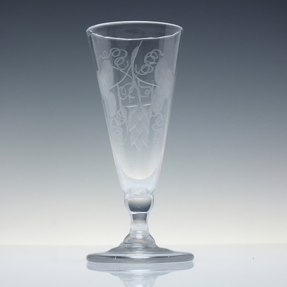 Pair of clear Georgian lead glass ale flutes featuring wheel-engraved barley and hops decoration on knopped stems. View III
