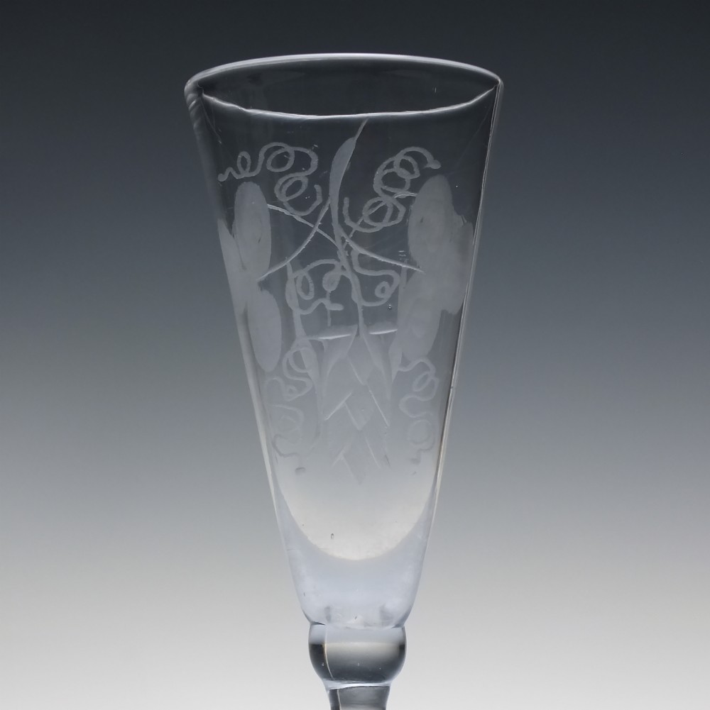 Pair of clear Georgian lead glass ale flutes featuring wheel-engraved barley and hops decoration on knopped stems. View IV