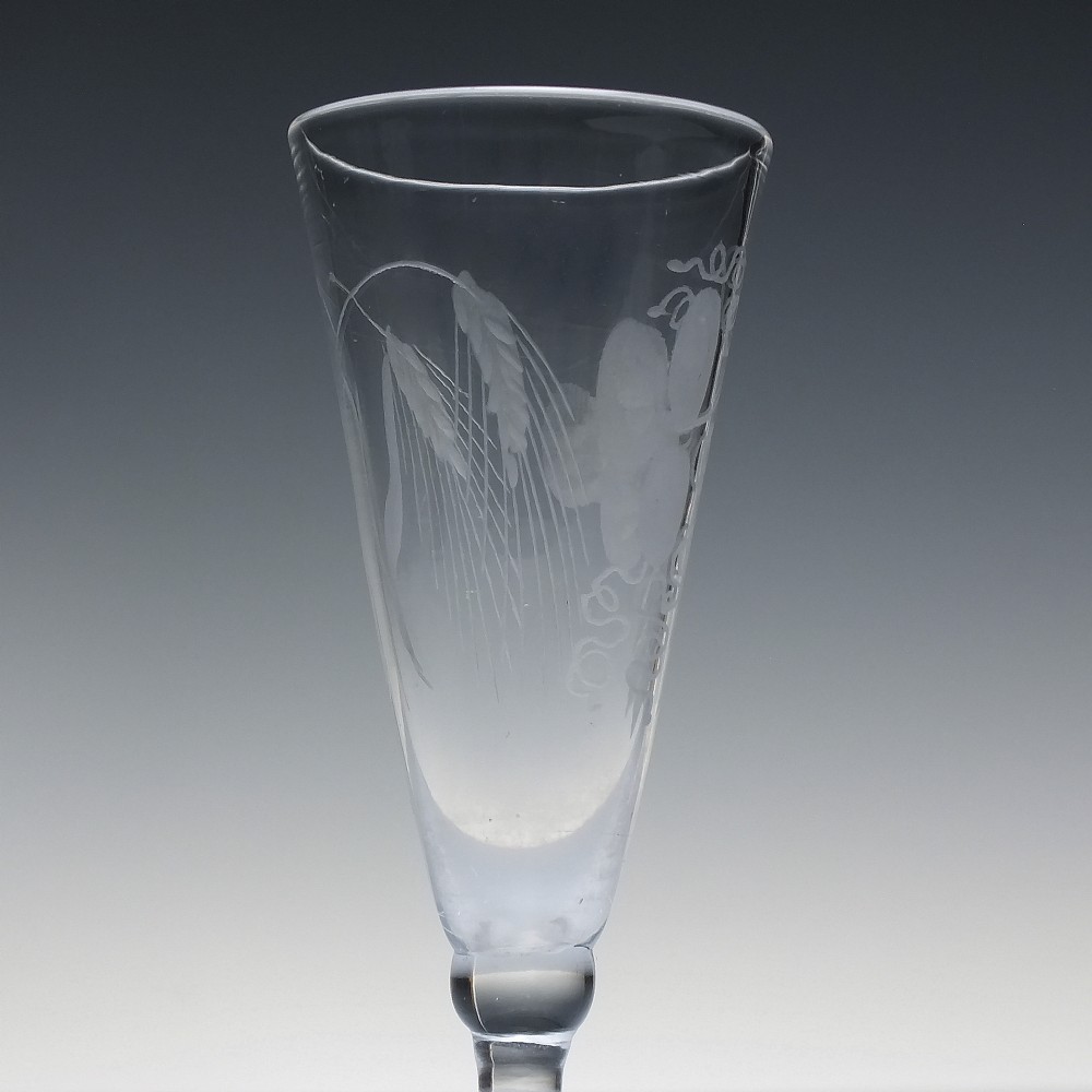 Pair of clear Georgian lead glass ale flutes featuring wheel-engraved barley and hops decoration on knopped stems. View V