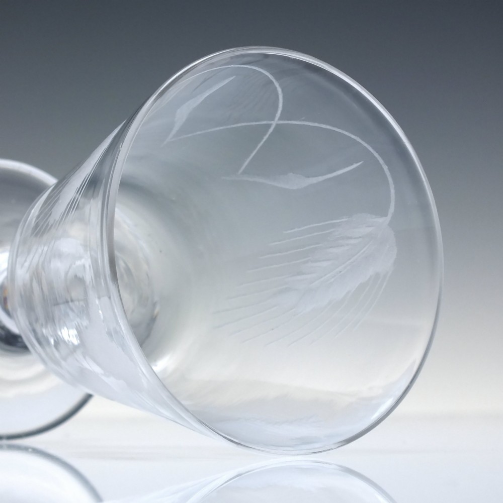 A clear Georgian glass rummer with a cup-shaped bowl wheel-engraved with hop and barley motifs, set on a short knopped stem and flat circular base. View VI