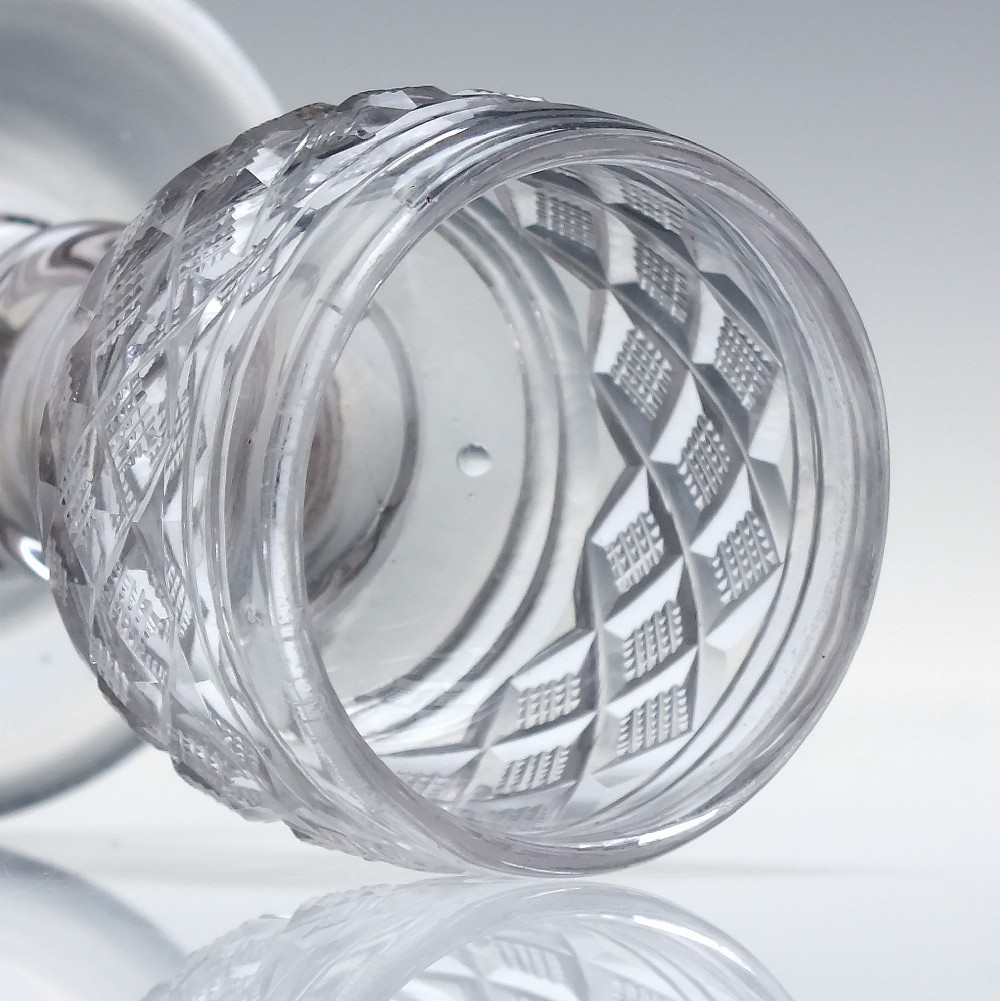 A pair of early 19th-century clear cut lead crystal dram glasses featuring diamond cutting and knopped stems. View III