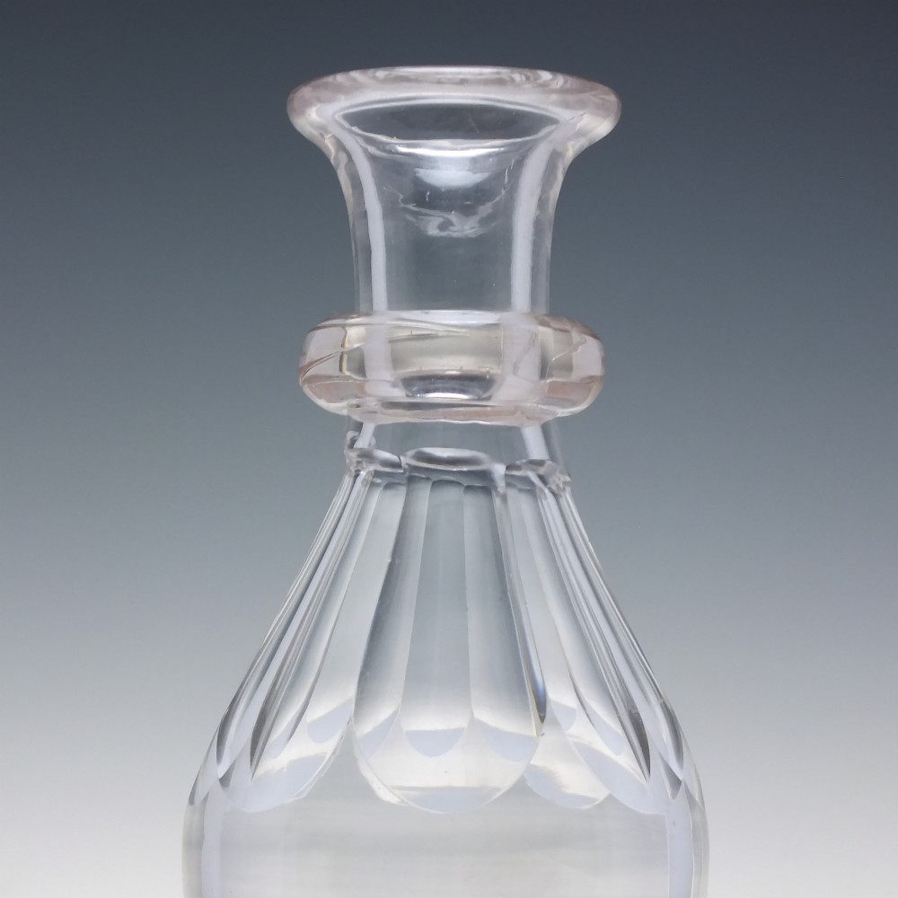 A clear hand-blown glass Scottish whisky measure featuring a flared rim, applied neck ring, and cut shoulder flutes. View II