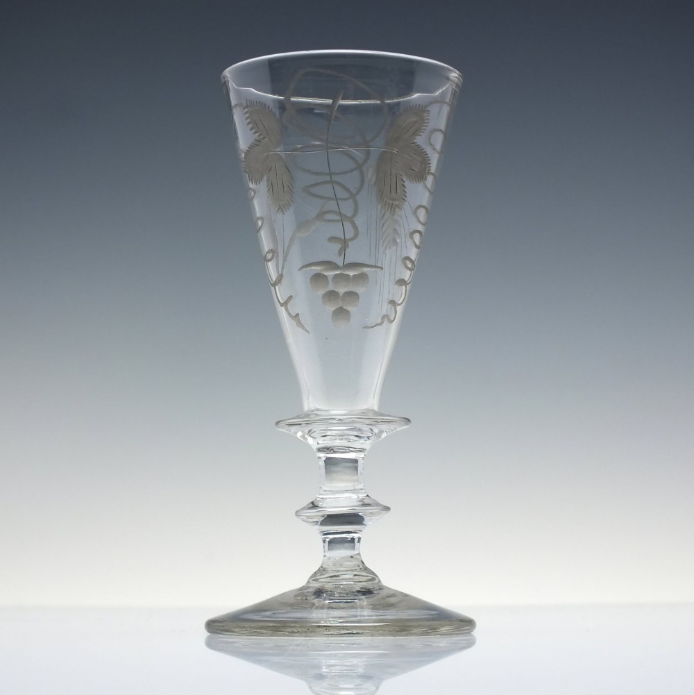 A pair of clear hand-blown Georgian glass goblets featuring wheel-engraved motifs of hops and barley on conical bowls above knopped stems and conical bases. View III